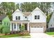 Stunning two-story home with white siding, brick accents, and a welcoming front porch at 122 Sanderway Dr, Chapel Hill, NC 27516