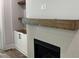 Elegant fireplace with a decorative tile surround, wooden mantel, and built-in shelving at 122 Sanderway Dr, Chapel Hill, NC 27516