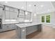 Open kitchen with gray cabinets, stainless steel appliances, and a large central island at 122 Sanderway Dr, Chapel Hill, NC 27516
