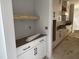 Kitchen with white cabinets, black hardware, open shelf area, light countertop, and clean design at 122 Sanderway Dr, Chapel Hill, NC 27516