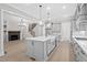 Modern kitchen with gray cabinets, a spacious island, and open access to the living room at 122 Sanderway Dr, Chapel Hill, NC 27516