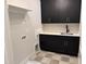 Laundry room featuring matte black cabinets with sleek gold hardware and a countertop matching the backsplash at 122 Sanderway Dr, Chapel Hill, NC 27516
