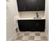 Modern laundry room featuring a sleek black faucet and cabinets with long gold hardware at 122 Sanderway Dr, Chapel Hill, NC 27516