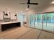 Living room with kitchen, island, and screened in porch with trees at 122 Sanderway Dr, Chapel Hill, NC 27516