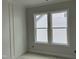 Living room featuring wainscoting, neutral gray paint, ample natural light from large windows, and clean design at 122 Sanderway Dr, Chapel Hill, NC 27516