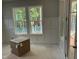 Living room featuring wainscoting, neutral gray paint, ample natural light from large windows, and clean design at 122 Sanderway Dr, Chapel Hill, NC 27516