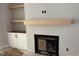 Living room featuring a fireplace with wood mantel, built in cabinets, and neutral gray paint at 122 Sanderway Dr, Chapel Hill, NC 27516