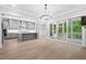 Bright open-concept living space with hardwood floors and access to a screened-in porch at 122 Sanderway Dr, Chapel Hill, NC 27516