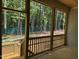 Screened-in porch offering an open view of the treed backyard, new wooden stairs, and fresh design at 122 Sanderway Dr, Chapel Hill, NC 27516