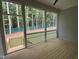 Screened in porch overlooking the backyard with wood decking and railing at 122 Sanderway Dr, Chapel Hill, NC 27516