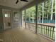 Screened in porch overlooking the backyard with wood decking and railing at 122 Sanderway Dr, Chapel Hill, NC 27516
