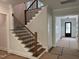Elegant staircase with wooden treads, black iron balusters, and white risers at 122 Sanderway Dr, Chapel Hill, NC 27516