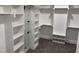 Spacious walk-in closet boasting custom built-in shelving, carpet, and a full-length mirror at 122 Sanderway Dr, Chapel Hill, NC 27516