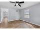 Bright bedroom with sleek ceiling fan, light-blue walls and wood-look flooring at 128 Warren Ave, Oxford, NC 27565