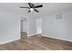 Comfortable bedroom with light-blue walls, wood-look flooring, and ceiling fan at 128 Warren Ave, Oxford, NC 27565