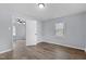 Bright bedroom featuring wood-look flooring and a view into the next room at 128 Warren Ave, Oxford, NC 27565