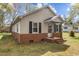 Delightful single-Gathering home with brick accents, neutral siding, and a covered porch, creating a welcoming entrance at 128 Warren Ave, Oxford, NC 27565