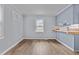 Cozy kitchen with wood-look floors, light blue walls, a window, and light wood countertops on the blue lower cabinets at 128 Warren Ave, Oxford, NC 27565