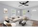 Bright living room featuring a large sectional sofa, neutral decor, and wood-look flooring at 128 Warren Ave, Oxford, NC 27565