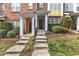 The entrance to the townhouses has inviting steps, brick, columns, and manicured bushes at 131 Dove Cottage Ln, Cary, NC 27519