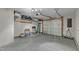 Spacious garage with epoxy flooring, overhead storage, and an automatic garage door at 131 Dove Cottage Ln, Cary, NC 27519