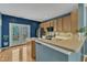Bright, modern kitchen leading to a patio, complete with stainless appliances and an island at 131 Dove Cottage Ln, Cary, NC 27519