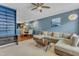 Open-concept living room with hardwood floors, plush sectional sofa, and contemporary lighting fixtures at 131 Dove Cottage Ln, Cary, NC 27519