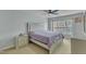 A spacious main bedroom with a large window, carpeted floors, and matching nightstands and dressers at 131 Dove Cottage Ln, Cary, NC 27519