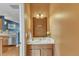 Charming half bathroom showcasing a vanity with a decorative mirror and warm wall colors at 131 Dove Cottage Ln, Cary, NC 27519