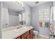 Bathroom with a single sink vanity, shower with tub, and bright light at 131 Hay Field Drive Dr, Clayton, NC 27520