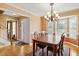 Bright dining area with hardwood floors, elegant chandelier, and views of the backyard at 131 Hay Field Drive Dr, Clayton, NC 27520