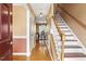 Inviting home entryway with hardwood floors, a staircase, and views into the dining area at 131 Hay Field Drive Dr, Clayton, NC 27520