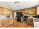 Functional kitchen with wooden cabinets, stainless steel appliances, and hardwood floors at 131 Hay Field Drive Dr, Clayton, NC 27520