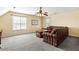 Spacious living room with cozy furniture, a ceiling fan, and two windows for plenty of natural light at 131 Hay Field Drive Dr, Clayton, NC 27520