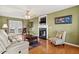 Comfortable living room featuring hardwood floors and a cozy fireplace at 131 Hay Field Drive Dr, Clayton, NC 27520