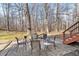 Outdoor seating on a stone patio with a view into the woods at 131 Hay Field Drive Dr, Clayton, NC 27520