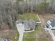 An aerial view of a beautiful property with a large lawn, garages, a long driveway, and mature trees at 1320 Blue Heron Dr, Nashville, NC 27856