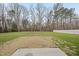 Spacious backyard with a mix of grassy areas and bare spots, bordered by trees and a white fence at 1320 Blue Heron Dr, Nashville, NC 27856