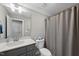 Bathroom with a shower and gray vanity has updated fixtures and ample storage at 1320 Blue Heron Dr, Nashville, NC 27856