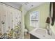 Bright bathroom with a shower and a window exudes cleanliness and features a modern vanity at 1320 Blue Heron Dr, Nashville, NC 27856