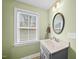 Bathroom featuring a window for natural light has a modern vanity and a warm, inviting ambiance at 1320 Blue Heron Dr, Nashville, NC 27856