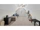 Spacious carpeted bonus room with a mini fridge and cozy seating creates an ideal entertainment or play area at 1320 Blue Heron Dr, Nashville, NC 27856