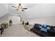 Large bonus room with a ceiling fan, sofa and neutral carpet is ready for entertaining and relaxation at 1320 Blue Heron Dr, Nashville, NC 27856