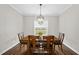 Cozy dining room featuring a wood dining table, chairs, a decorative chandelier, and a window with a view of the outdoors at 1320 Blue Heron Dr, Nashville, NC 27856