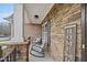 Charming front porch with decorative stone, cozy seating, and a welcoming 