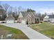 Gorgeous view of a brick home with a long driveway leading to two garages, surrounded by a well-kept lawn at 1320 Blue Heron Dr, Nashville, NC 27856