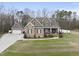 Charming brick home featuring a well-manicured lawn, a spacious driveway, and an attached two-car garage at 1320 Blue Heron Dr, Nashville, NC 27856