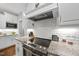 Close-up of a kitchen highlighting the white subway tile backsplash, granite countertops, and stainless-steel appliances at 1320 Blue Heron Dr, Nashville, NC 27856