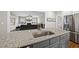 Kitchen island with a stainless-steel sink and granite countertop, with view to the living room at 1320 Blue Heron Dr, Nashville, NC 27856
