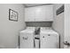 Laundry room features storage cabinets, washer and dryer at 1320 Blue Heron Dr, Nashville, NC 27856